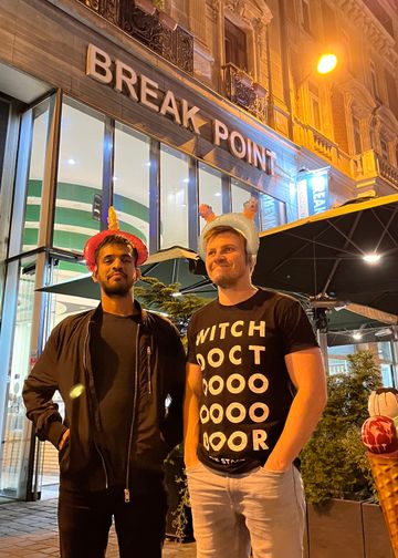 Me with a friend in front of a cafe called break point