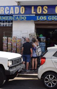 An elderly couple looking at souvenirs on a street shop in Los gigantes